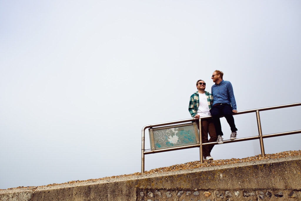 LGBTQ+ couple smiling during their Brighton engagement session