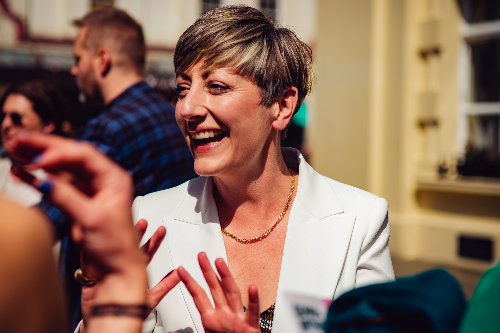 Natalie laughs as she talks to guests at the Brighton Town Hall before her wedding ceremony.