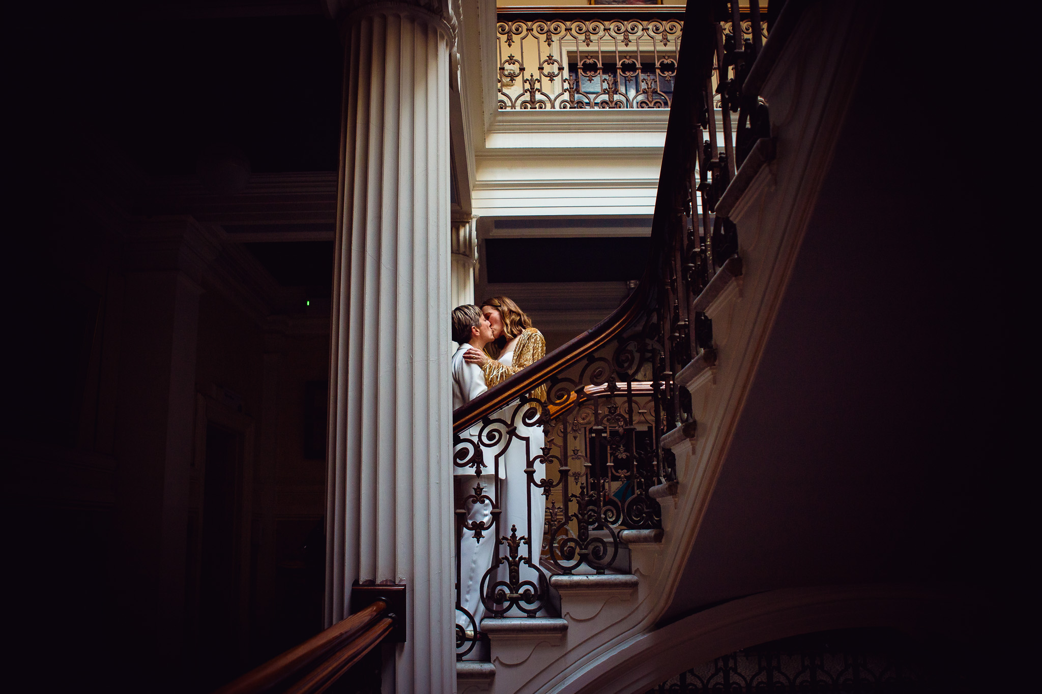 Gemma and Natalie share a kiss on the stairs after their wedding ceremony at Brighton Town Hall.