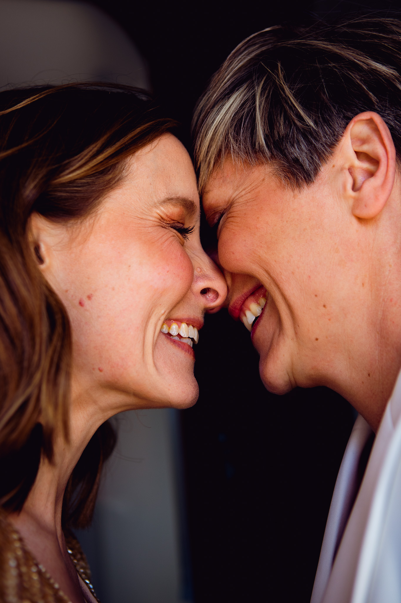 Gemma and Natalie touch foreheads and laugh as they pose for their couple shots in the Brighton lanes.