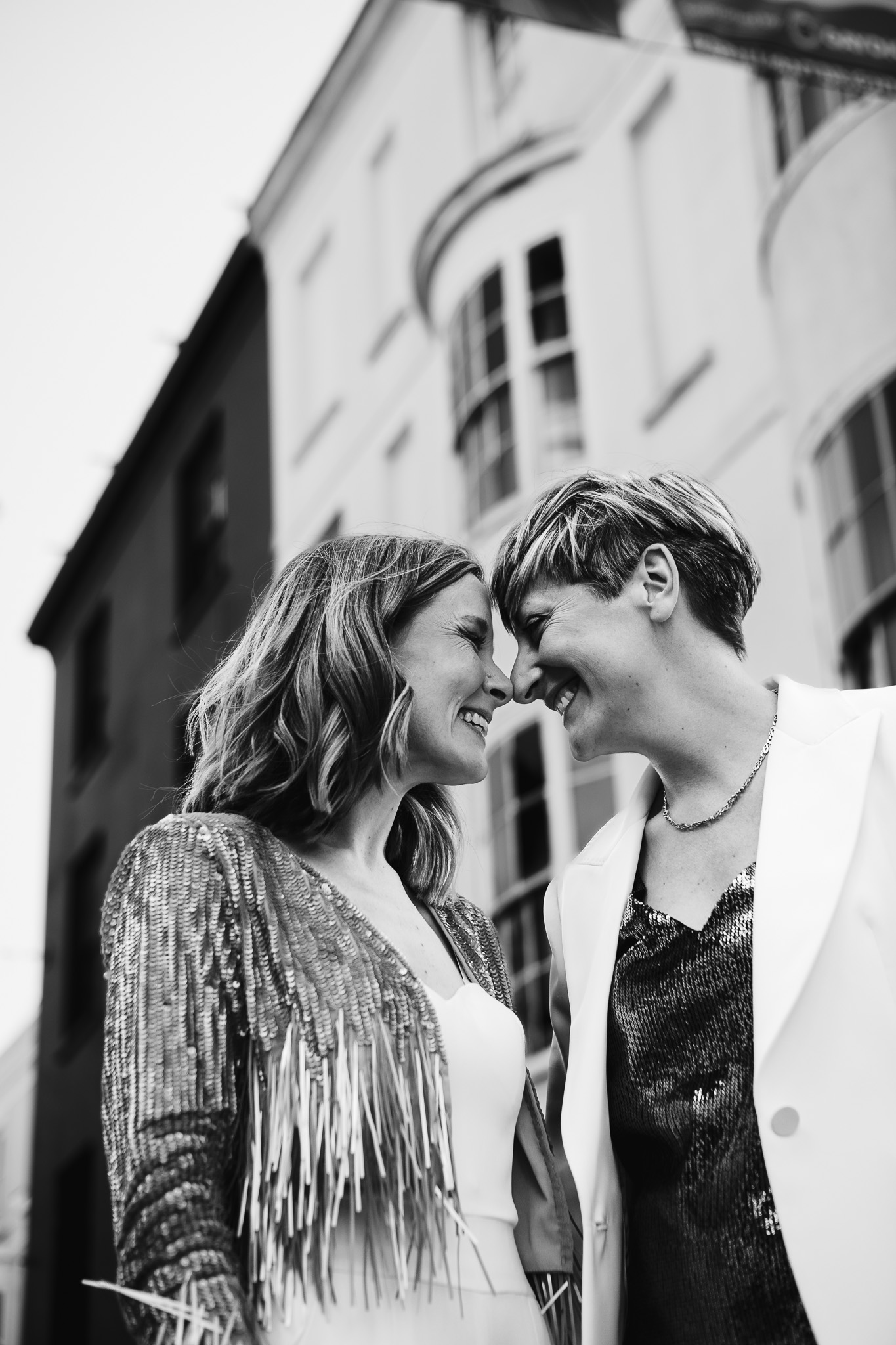 Gemma and Natalie smile at each other as they touch noses during their couple portraits in the Brighton lanes.