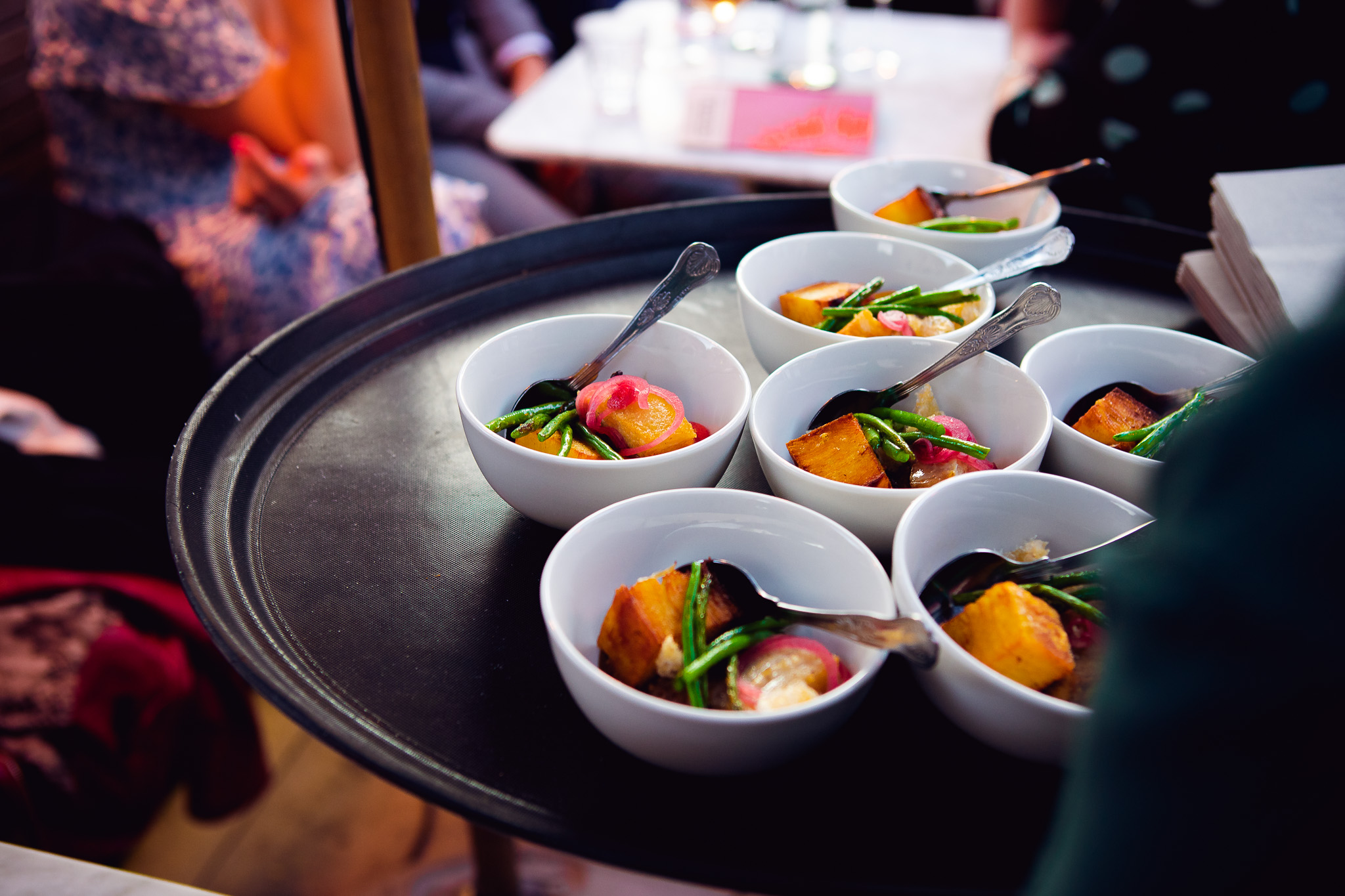 A colourful tray of small plates is brought out to the guests sitting on the Flint House terrace.